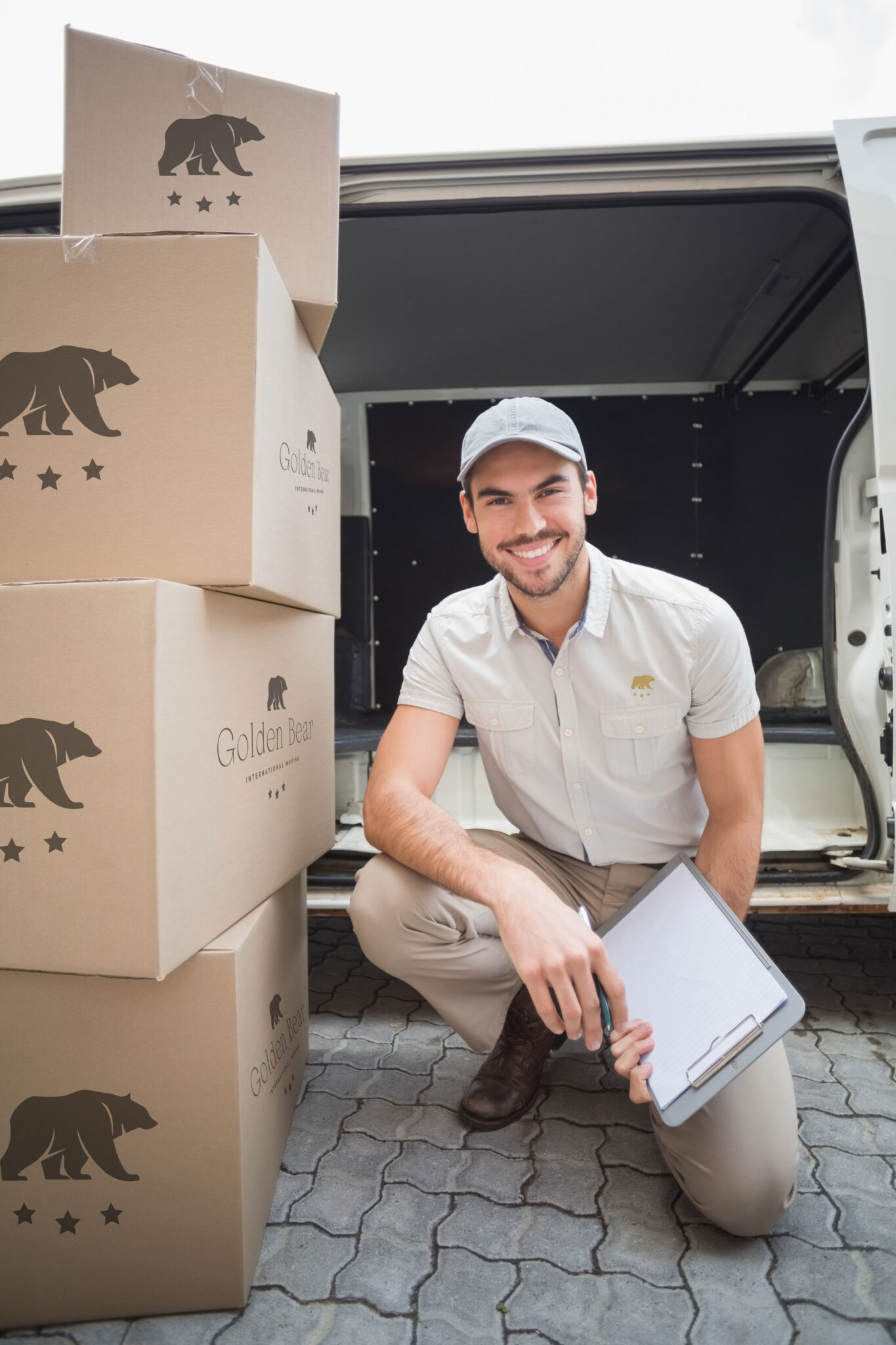 A Golden Bear crew member sealing a carton during a packing job.