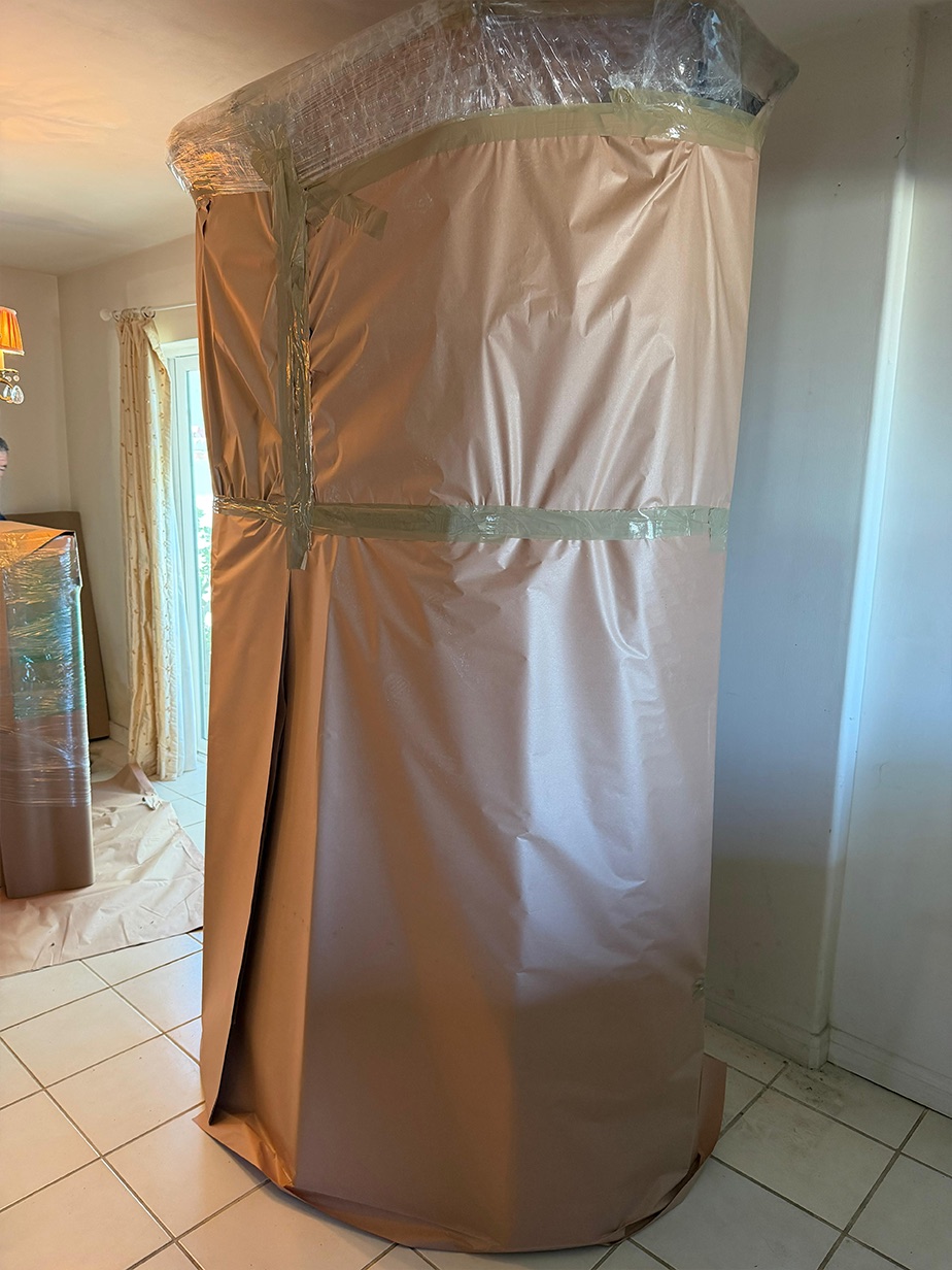 The same wrapped urn from the side, showing the layered paper and banding.