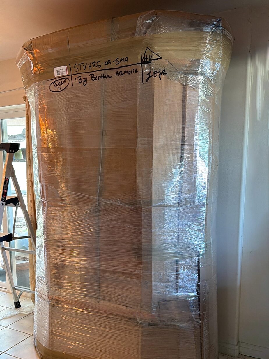 A large wrapped and labelled panel standing ready for inventory.