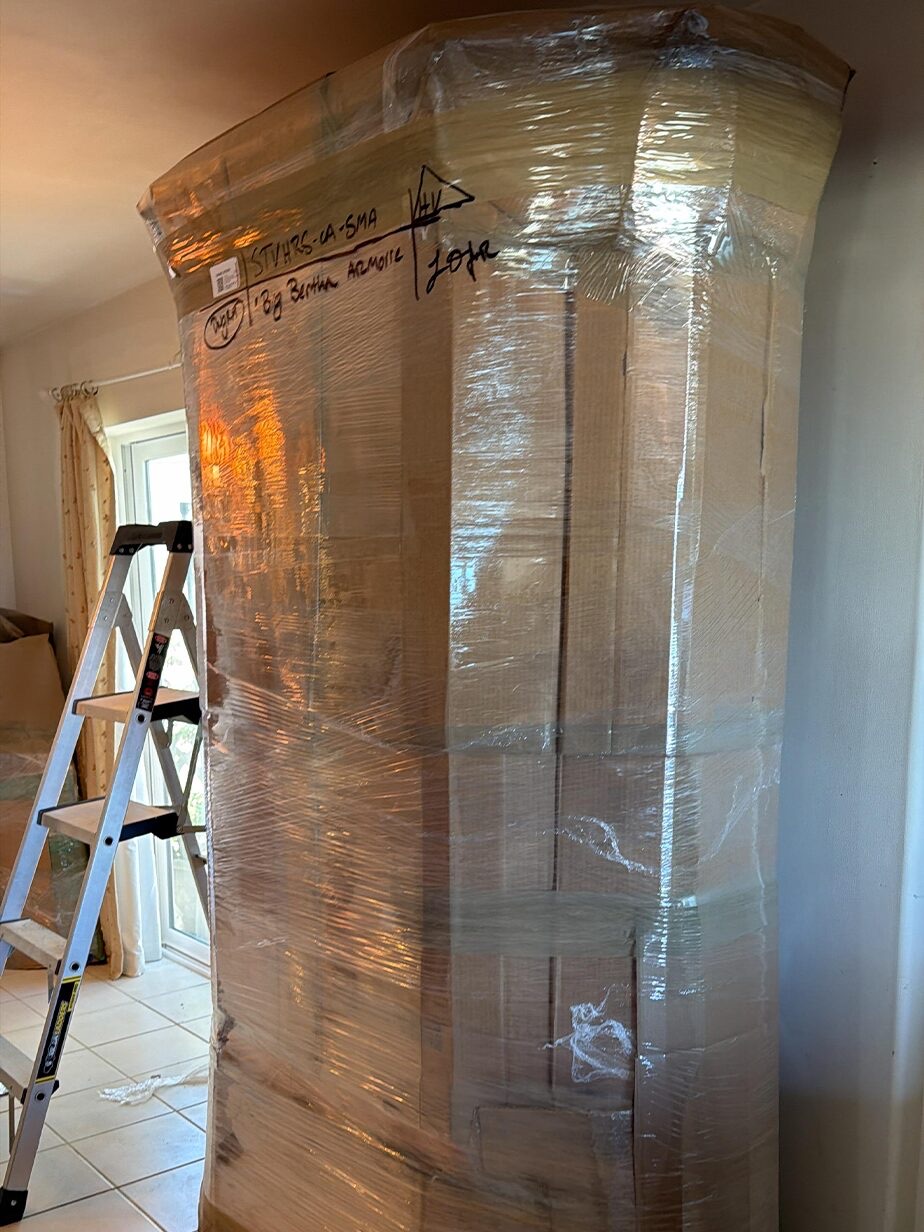 A tall wrapped and labelled piece secured for loading.